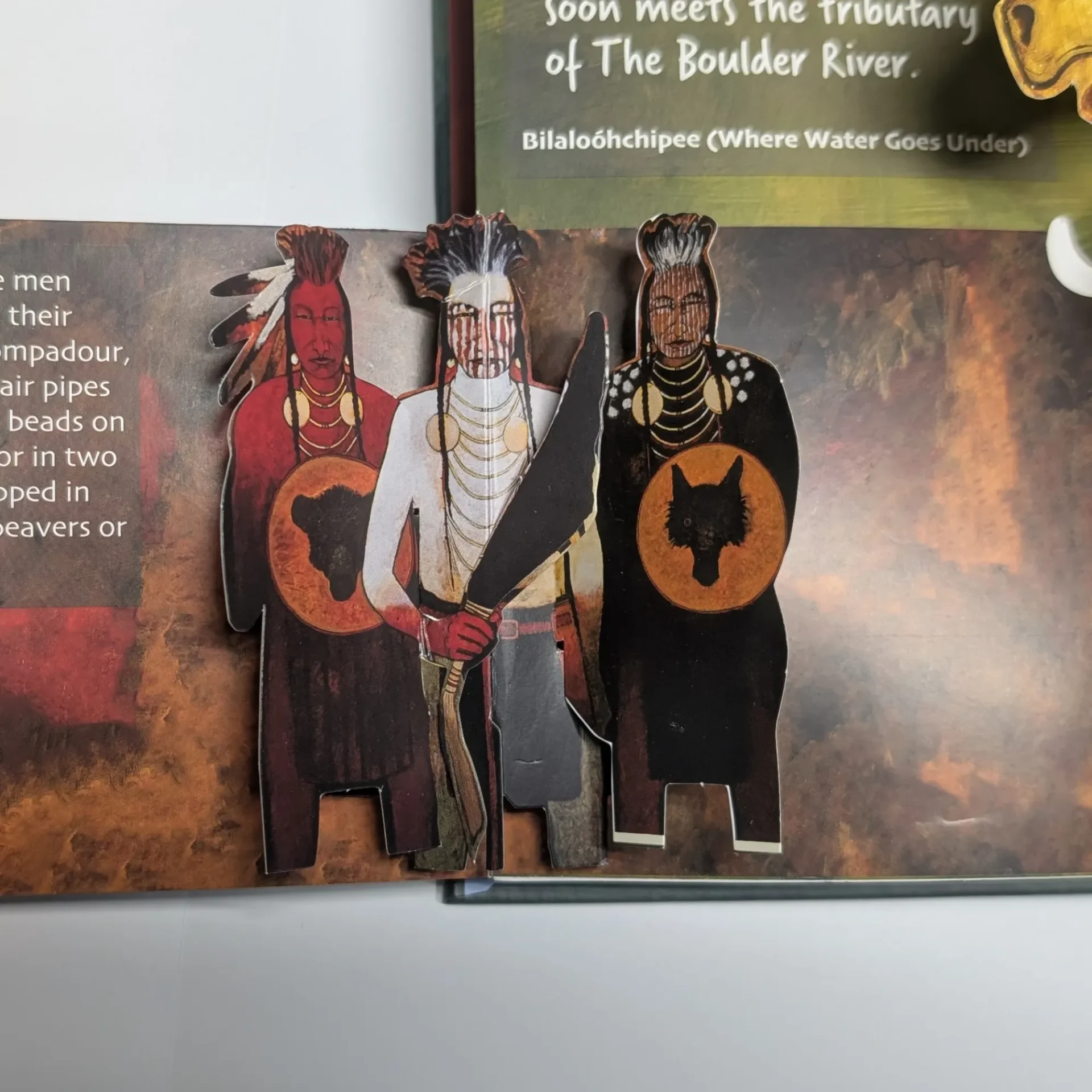 Miniature figurines of ancient warriors with shields and helmets.